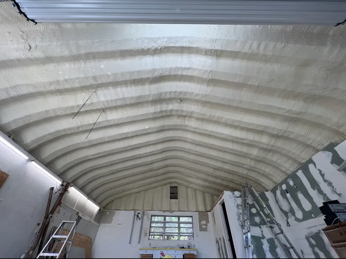 Spray polyurethane foam applied to the underside of a metal roof deck in Champlin